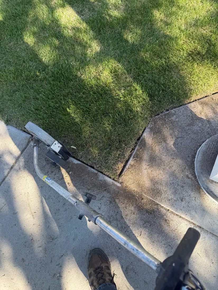 Edger at a sidewalk corner, seen from above